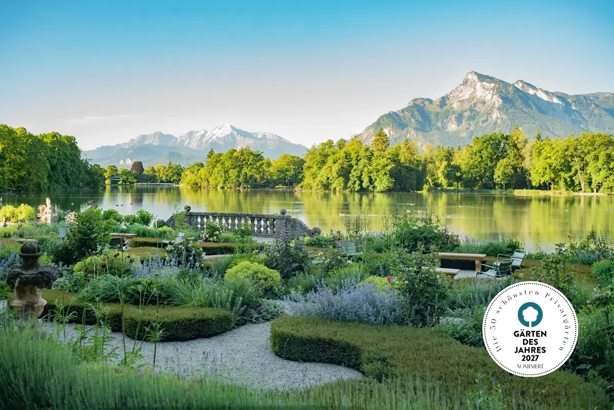 View from the rose garden at Leopoldskron Palace across the palace pond toward the Salzburg Alps at sunrise.